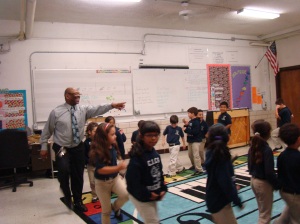 Doc playing London Bridge with his elementary students