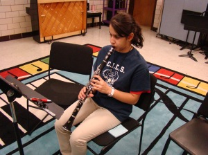 Calina Soto learning to play the clarinet