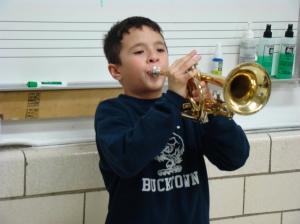 Carmello proudly shows Doc his progress on the trumpet