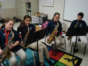 Yelena, Kailani, Elianna and Jaidan  learn how to play the saxophone during lunch